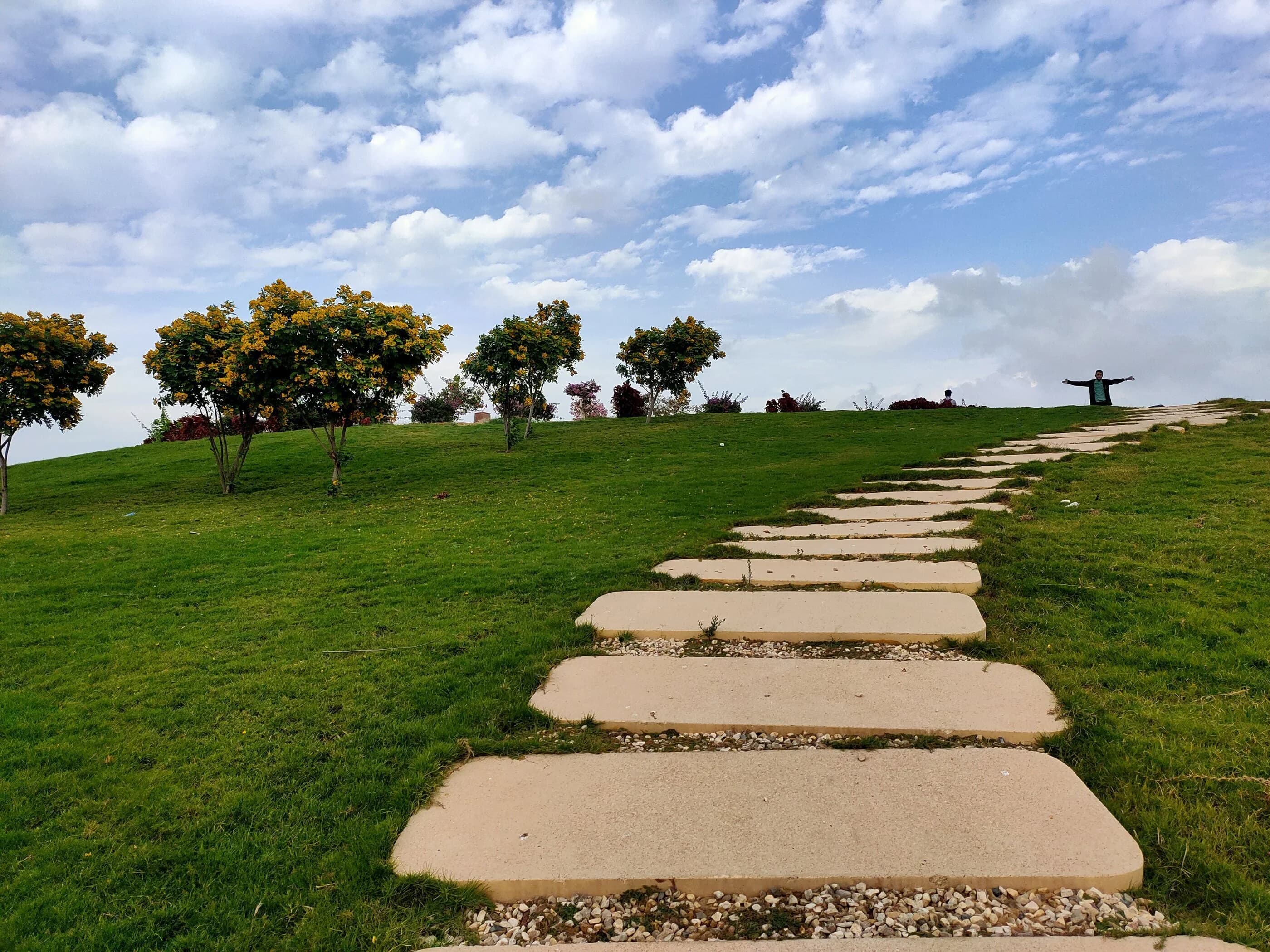 Ibrahim ( Ibra ) Gamal personal moment - scenic green hill with winding stone path leading to summit
